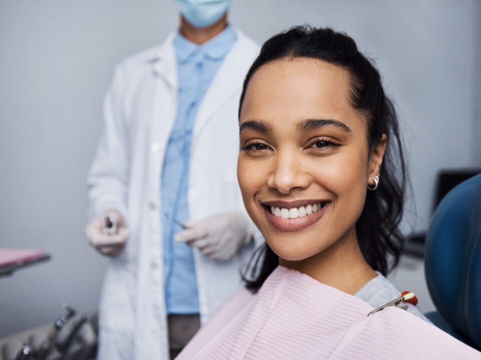 Patient sitting in the dental chair smiling with white teeth