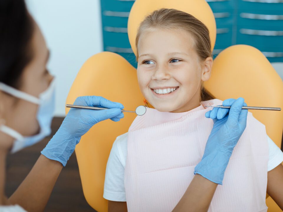 Child being examined by a dentist