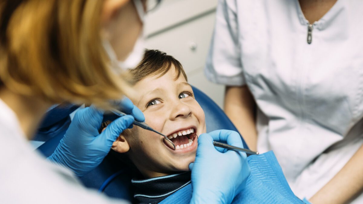 Pediatric patient receiving a dental exam
