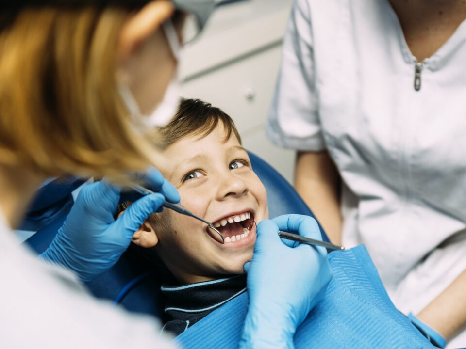 Pediatric patient receiving a dental exam