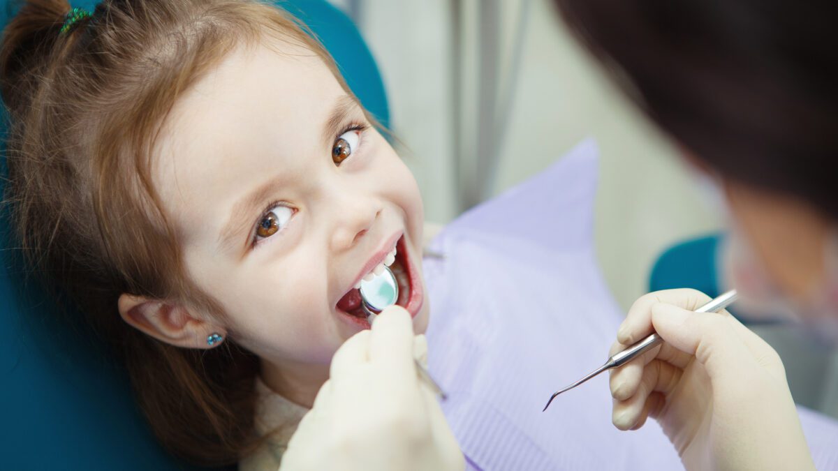 Child being examined by the dentist