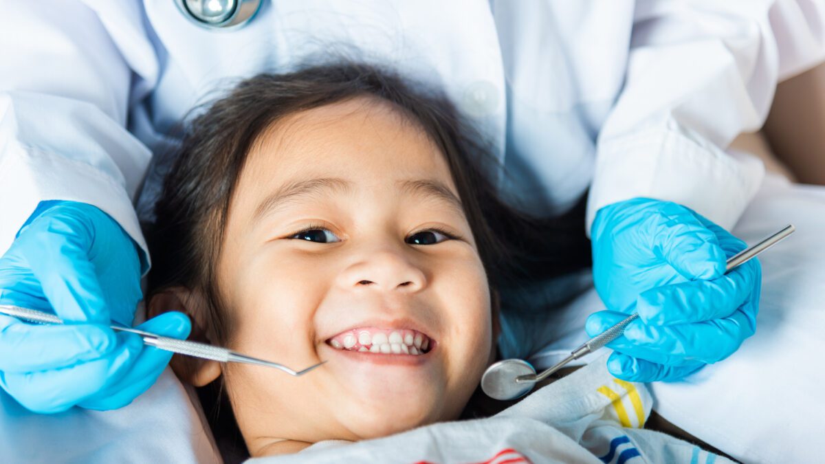 Child being examined by a dentist